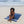 Femme allongée sur une fouta de plage couleur bleu marine - BY FOUTAS