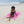 Woman reclining on a fuchsia-colored beach fouta - BY FOUTAS