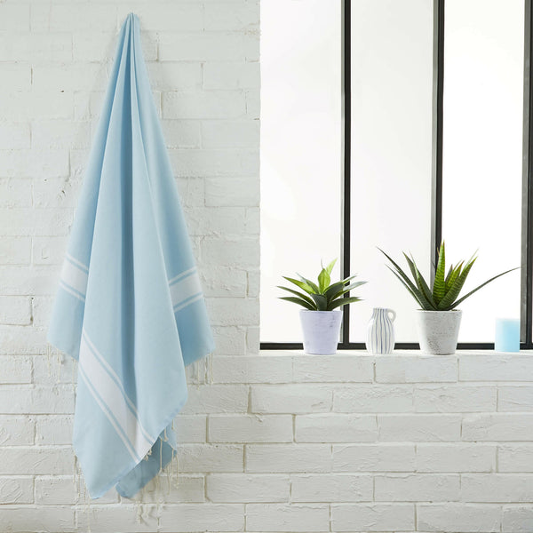 fouta flat weave sky blue color hanging in a bathroom - BY FOUTAS