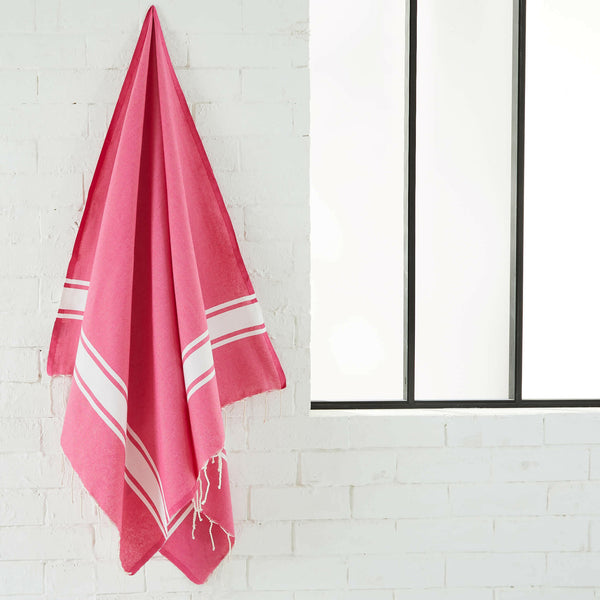 fouta flat weave fuchsia color hanging in a bathroom - BY FOUTAS