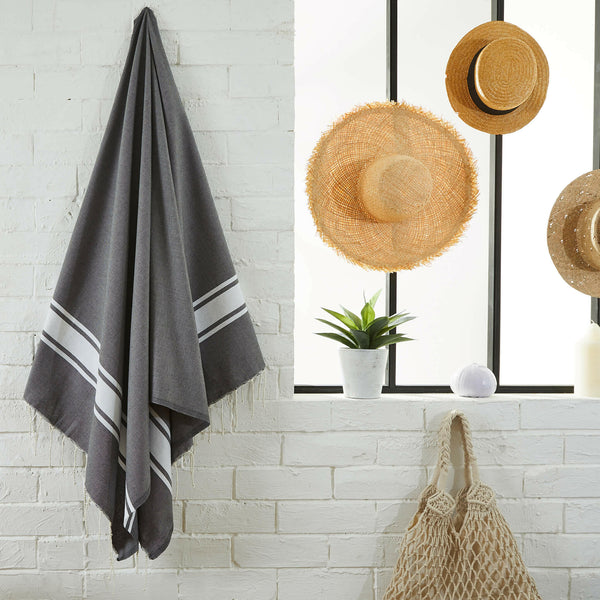 fouta flat weave concrete gray color hanging in a bathroom - BY FOUTAS