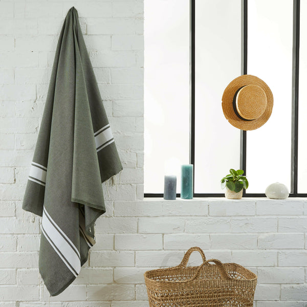 fouta flat weave olive color hanging in a bathroom - BY FOUTAS