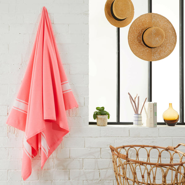 fouta flat weave fluorescent pink color hanging in a bathroom - BY FOUTAS