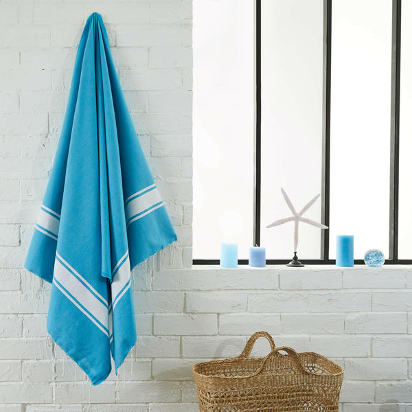 fouta flat weave turquoise color hanging in a bathroom - BY FOUTAS