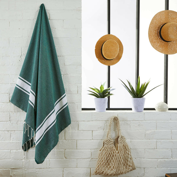 fouta flat weave fir green color hanging in a bathroom - BY FOUTAS