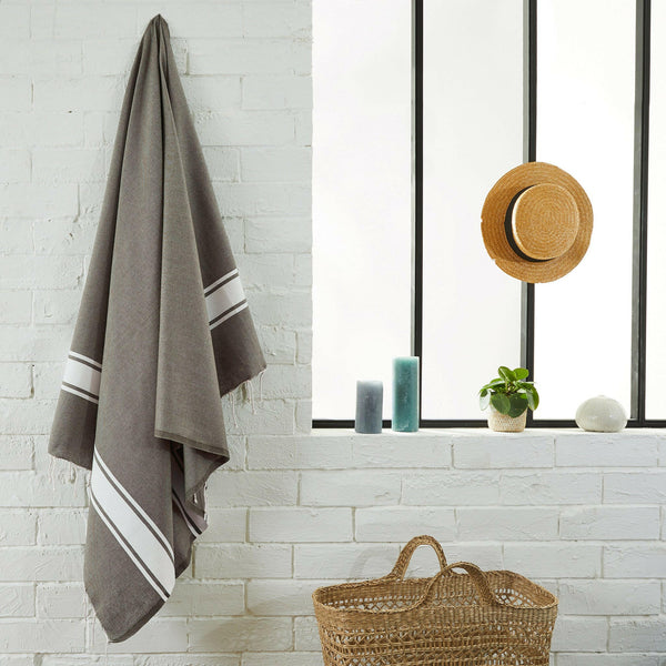 fouta flat weave taupe color hanging in a bathroom - BY FOUTAS