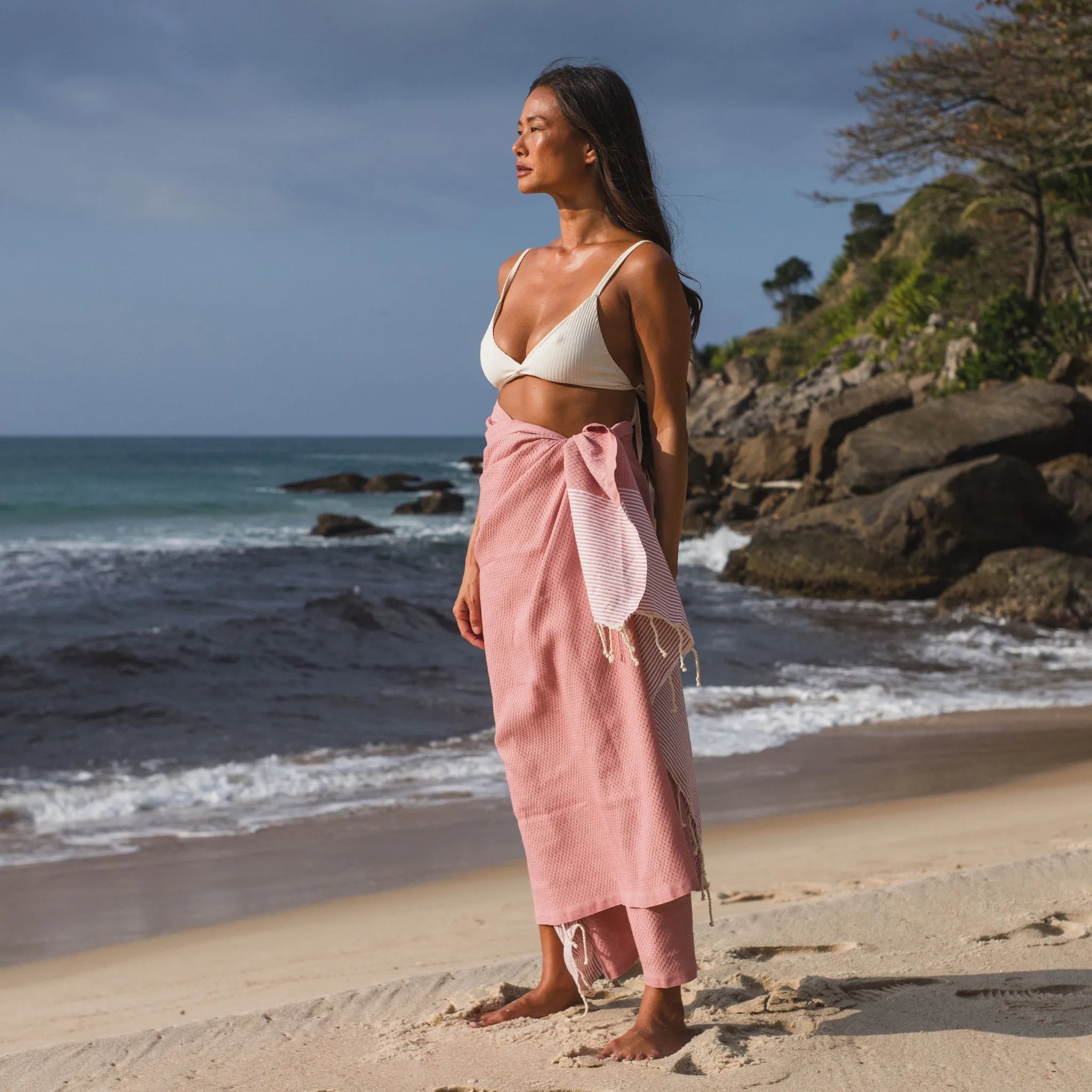 Donna che usa una Fouta a nido d'ape rosa cipria - BY FOUTAS