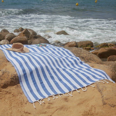 Woman using an Ocean Blue Positano Fouta - BY FOUTAS
