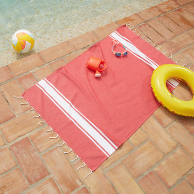 Woman using a Red Kids' Fouta - BY FOUTAS