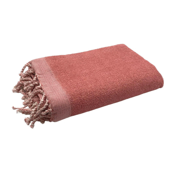 fouta Eponge unie couleur rose poudrée pliée façon serviette de bain côté éponge - BY FOUTAS
