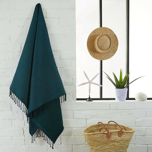 fouta Sponge plain fir green color hanging in a bathroom - BY FOUTAS