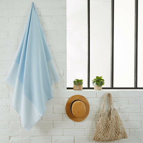Honeycomb fouta sky blue color hanging in a bathroom - BY FOUTAS