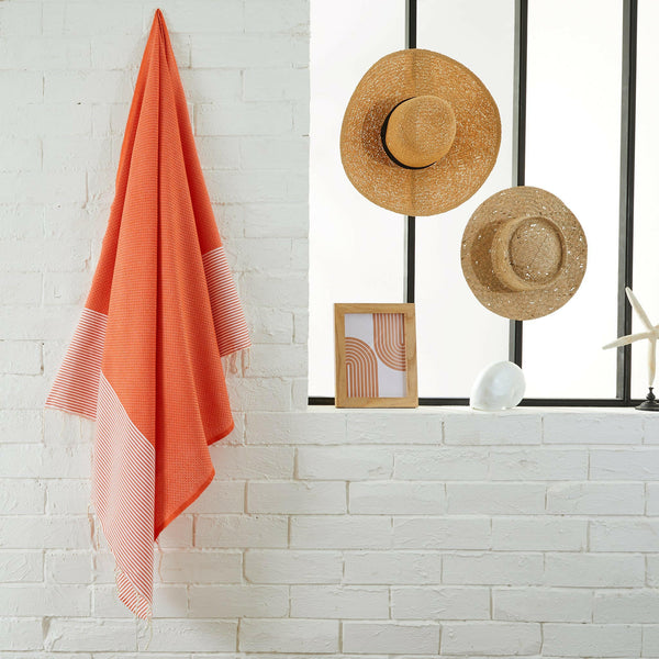 fouta Honeycomb orange color hanging in a bathroom - BY FOUTAS