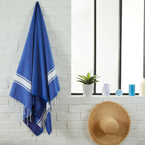 fouta flat weave ocean blue color hanging in a bathroom - BY FOUTAS