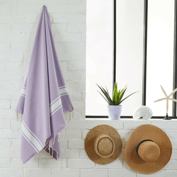 fouta flat weave lilac color hanging in a bathroom - BY FOUTAS