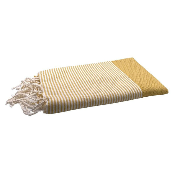fouta Honeycomb color mustard yellow folded as a beach towel - BY FOUTAS