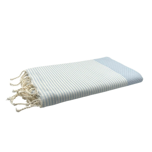 fouta Honeycomb color sky blue folded as a beach towel - BY FOUTAS