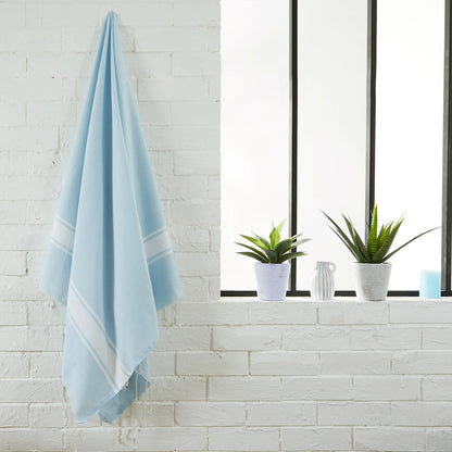 Woman using a Sky Blue Classic Fouta - BY FOUTAS