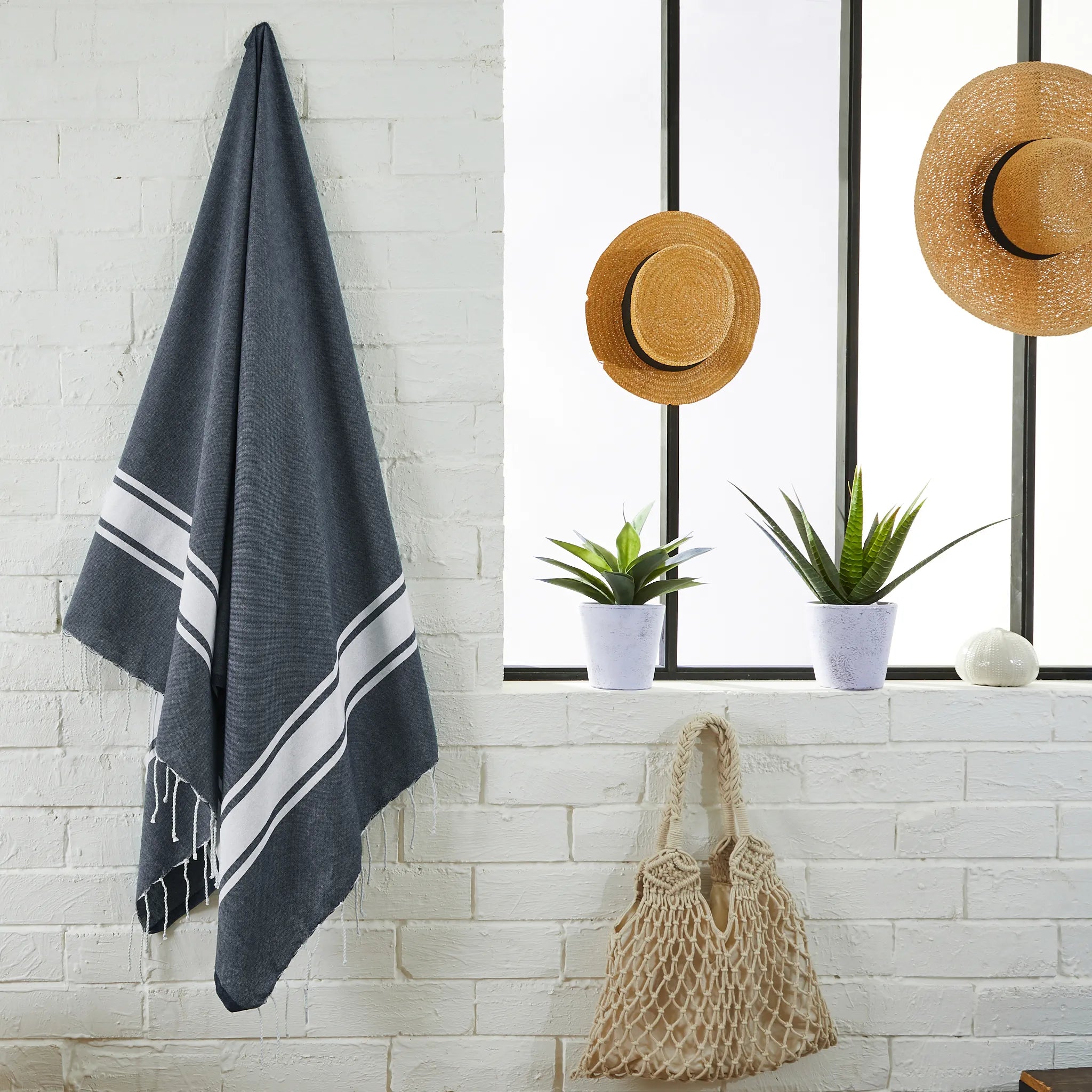 Woman using a Navy Blue Classic Fouta - BY FOUTAS