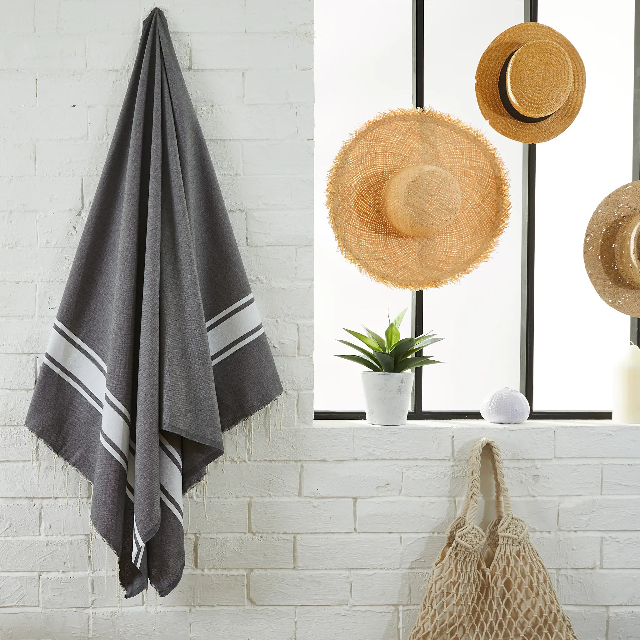 Woman using a Classic Dark Grey Fouta - BY FOUTAS