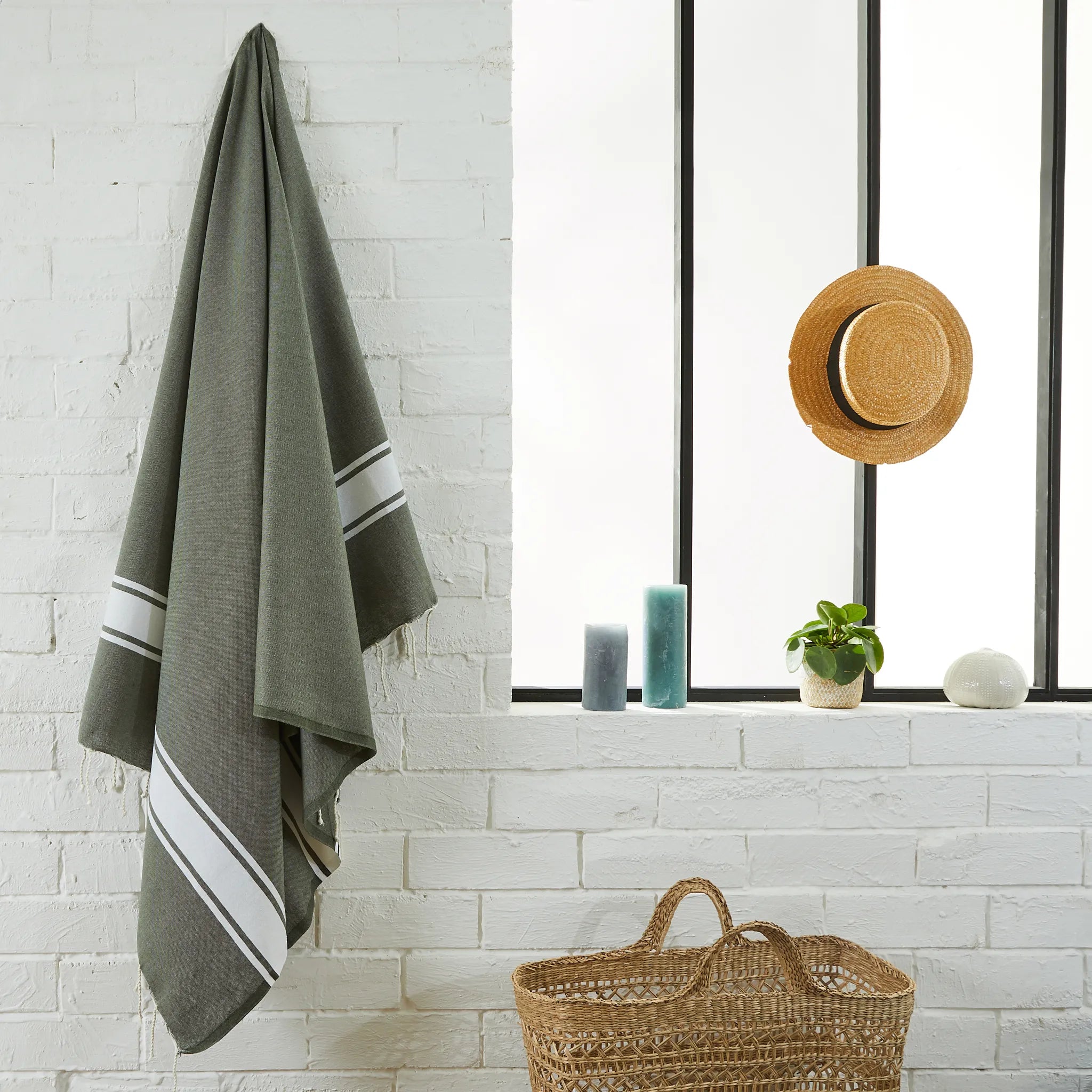 Woman using a Classic Olive Green Fouta - BY FOUTAS