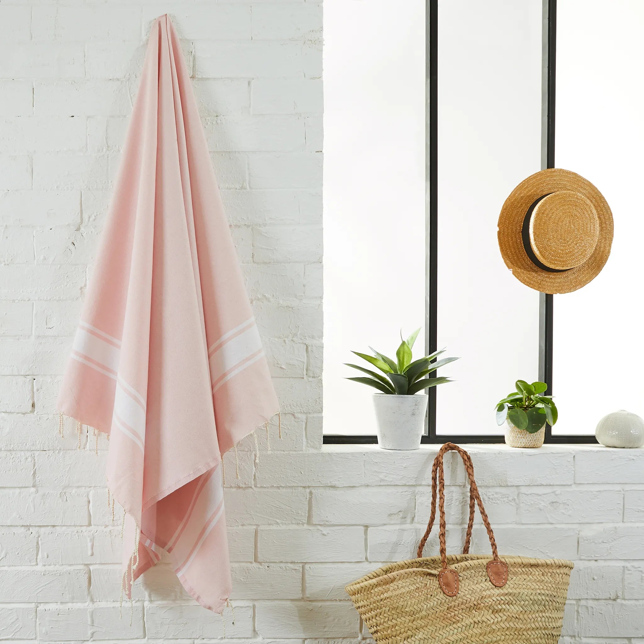 Woman using a Pink Classic Fouta - BY FOUTAS