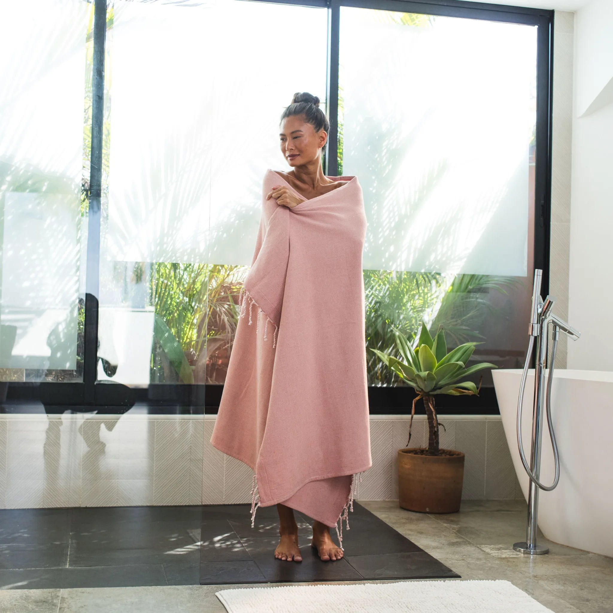 Woman using a Powder Pink Sponge Fouta - BY FOUTAS