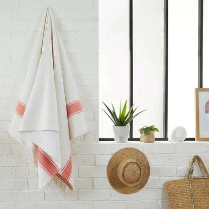 Woman using a White/Mandarin Sponge Fouta - BY FOUTAS