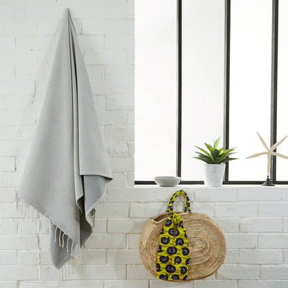 Woman using a Customizable Light Grey Sponge Fouta - BY FOUTAS