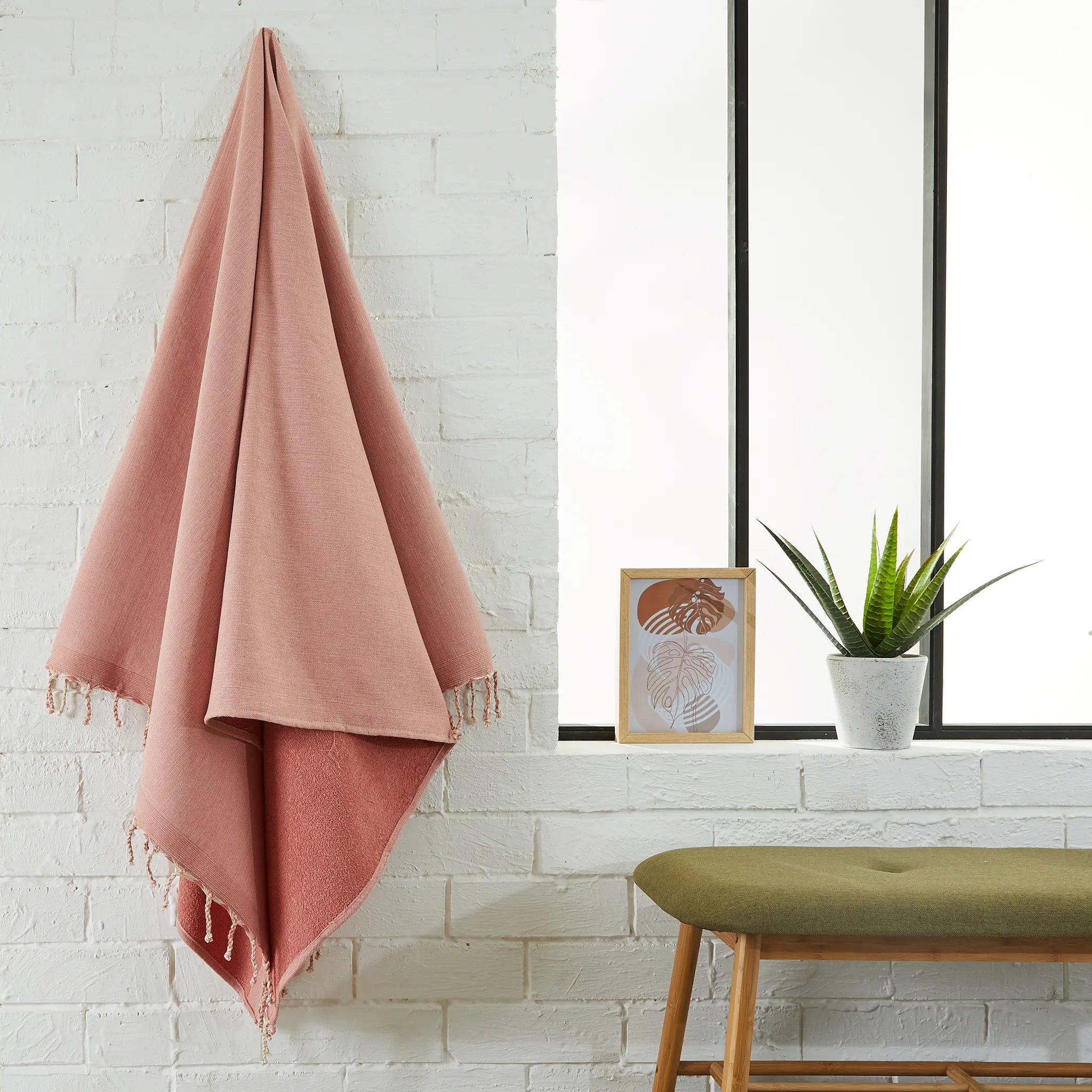 Woman using a Powder Pink Terry Fouta - BY FOUTAS