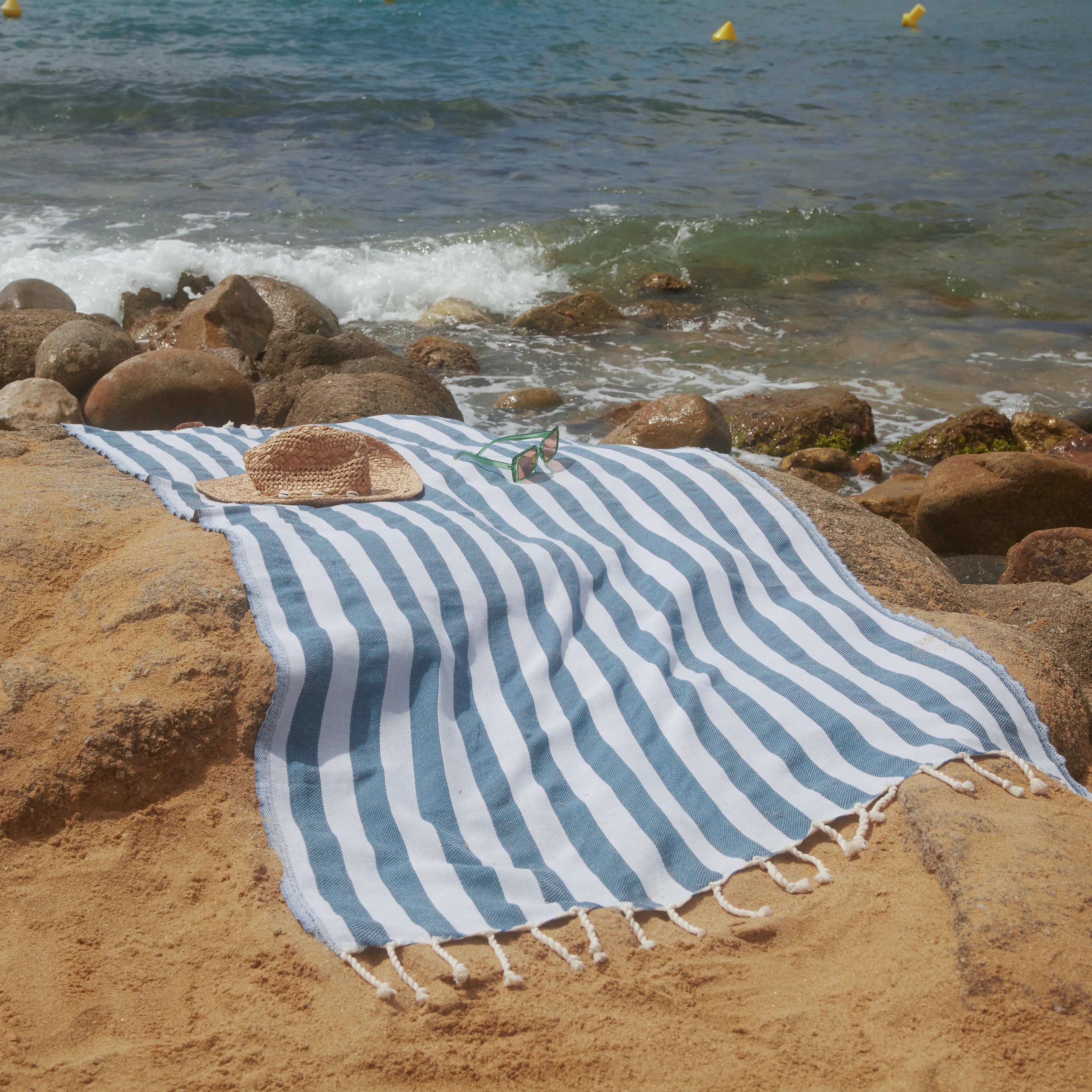 Woman using a Positano Duck Blue Fouta - BY FOUTAS