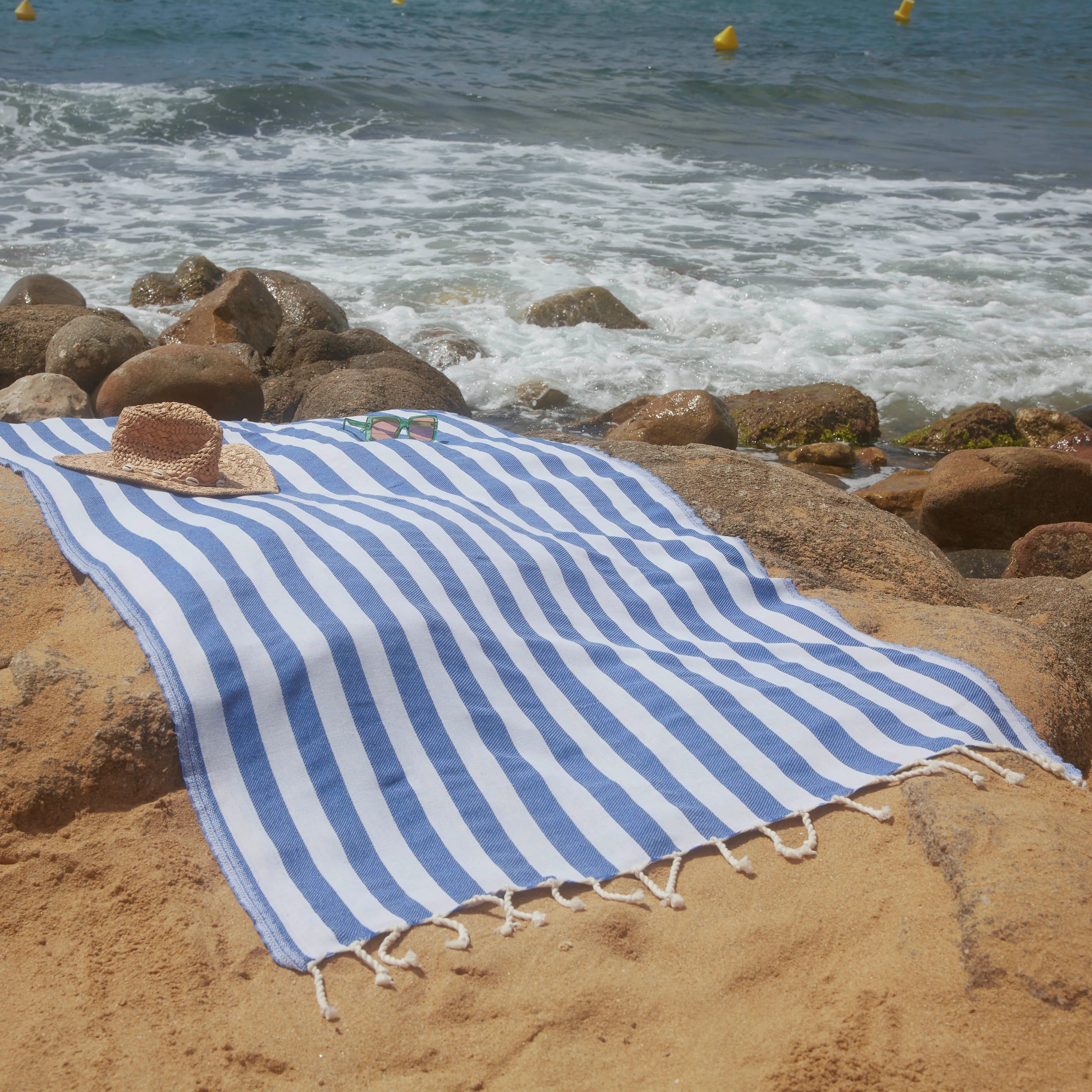 Woman using a Positano Ocean Blue Fouta - BY FOUTAS