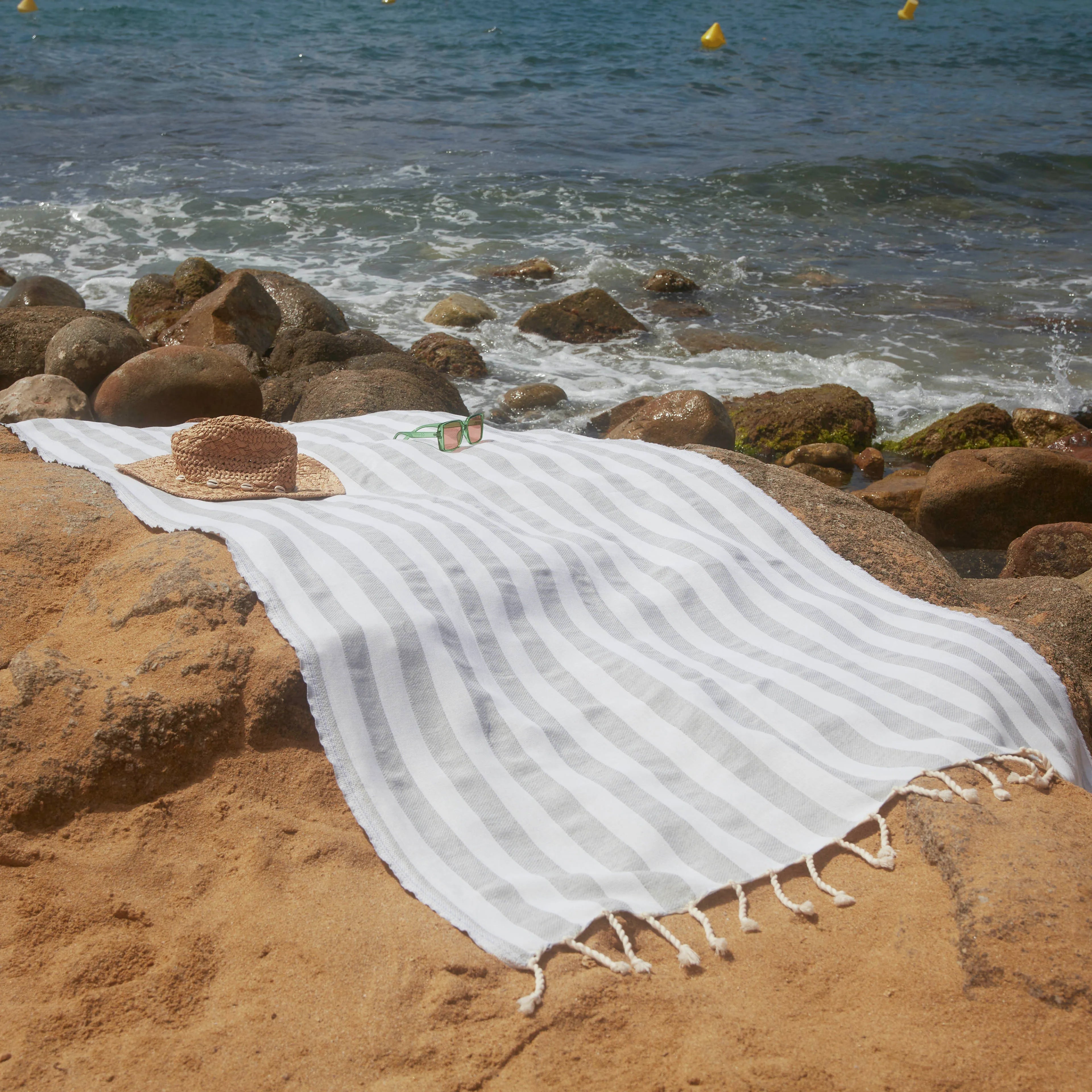 Woman using a Positano Light Grey Fouta - BY FOUTAS