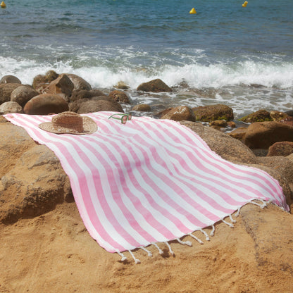 Woman using a pink Positano Fouta - BY FOUTAS