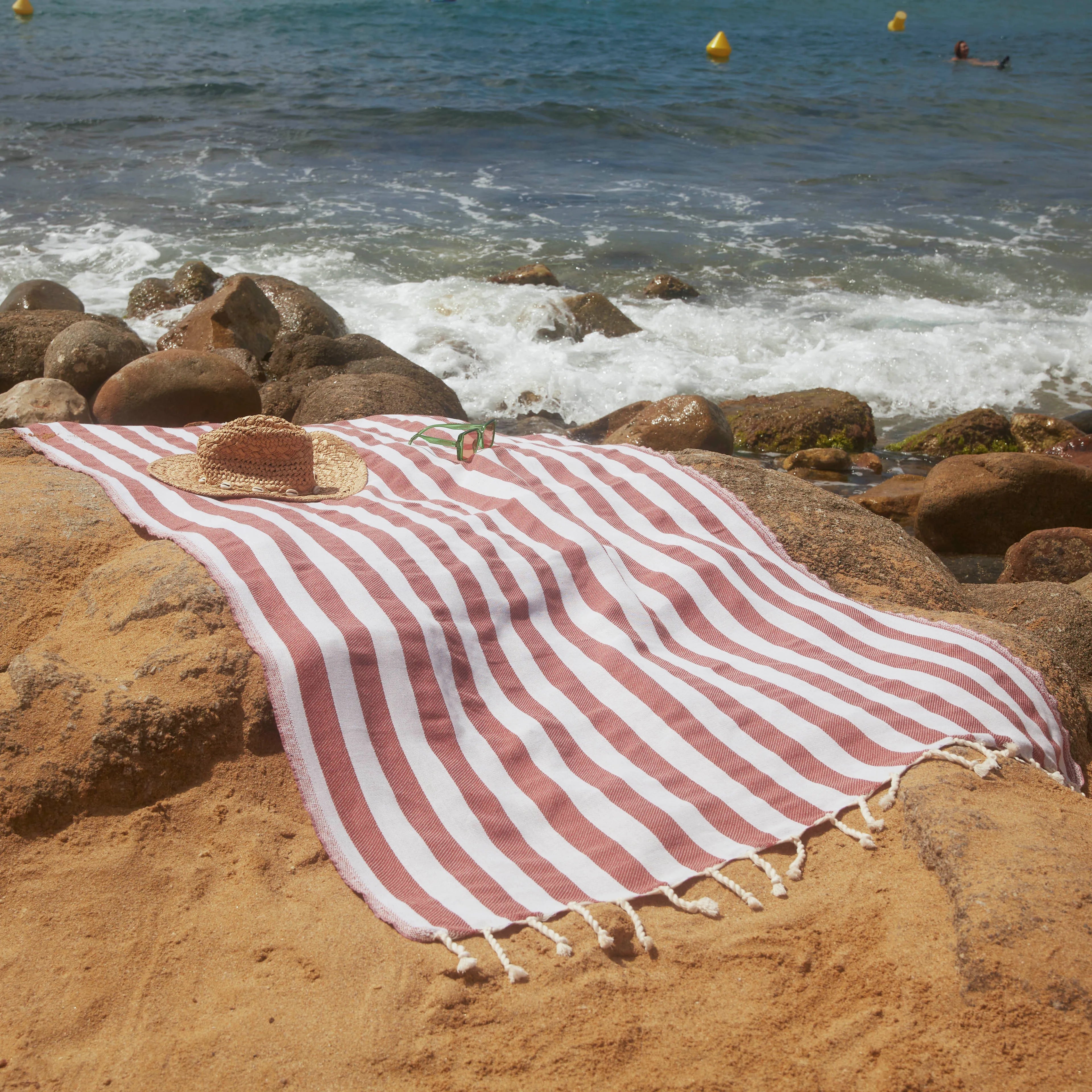 Woman using a Positano Terracotta Fouta - BY FOUTAS