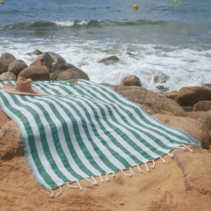 Woman using an Emerald Green Positano Fouta - BY FOUTAS