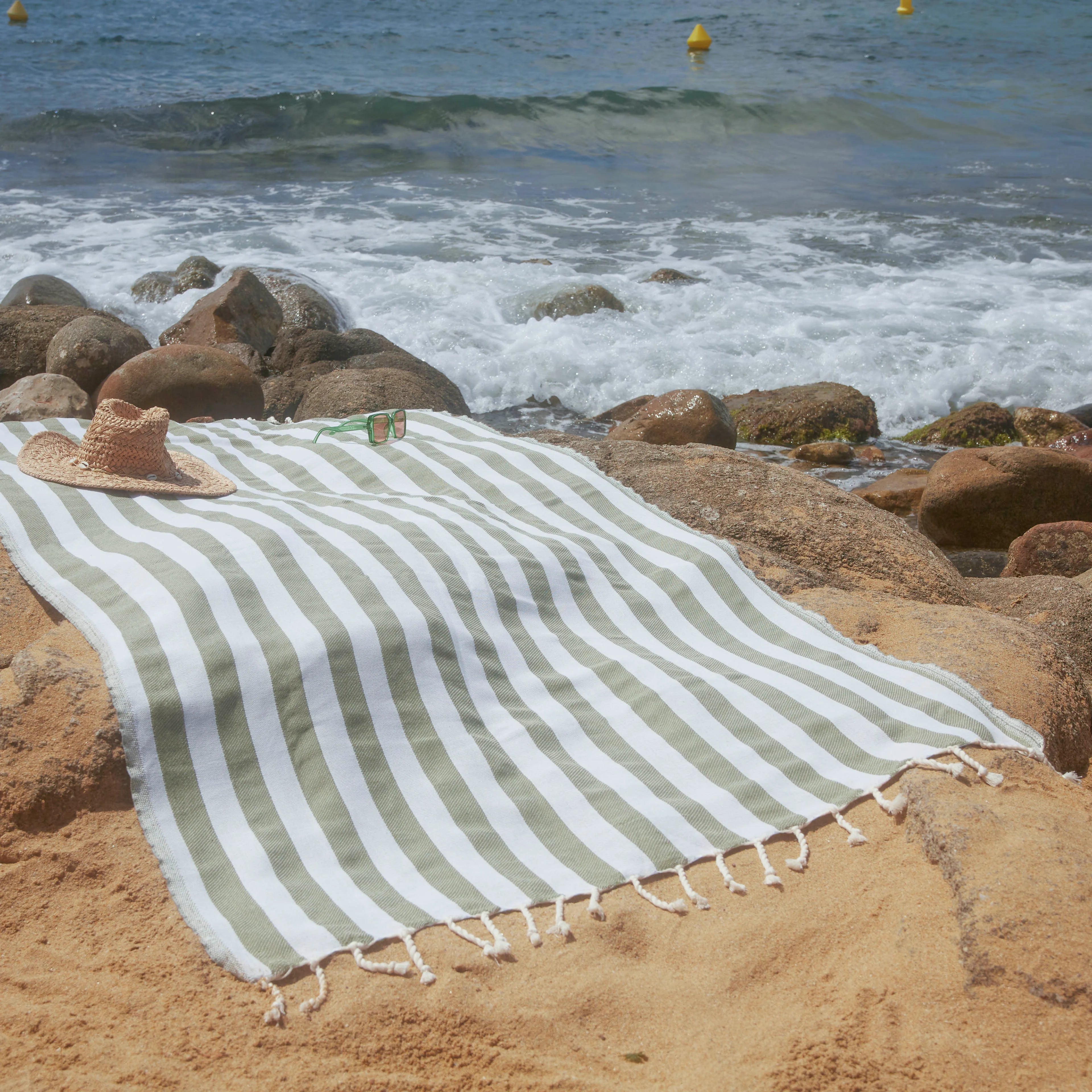 Woman using a Positano Fouta Olive Green - BY FOUTAS