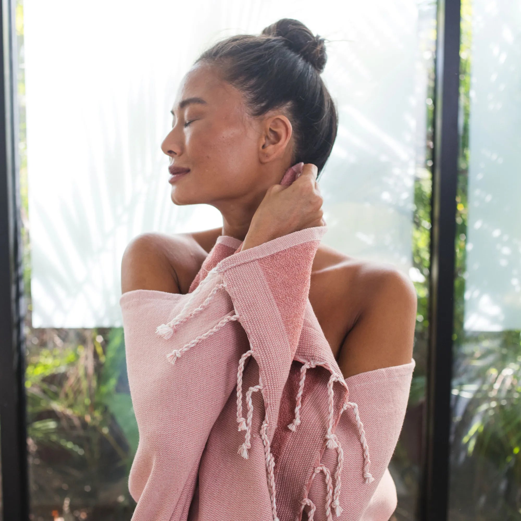 Woman drying off with a powder pink terry-lined fouta - BY FOUTAS