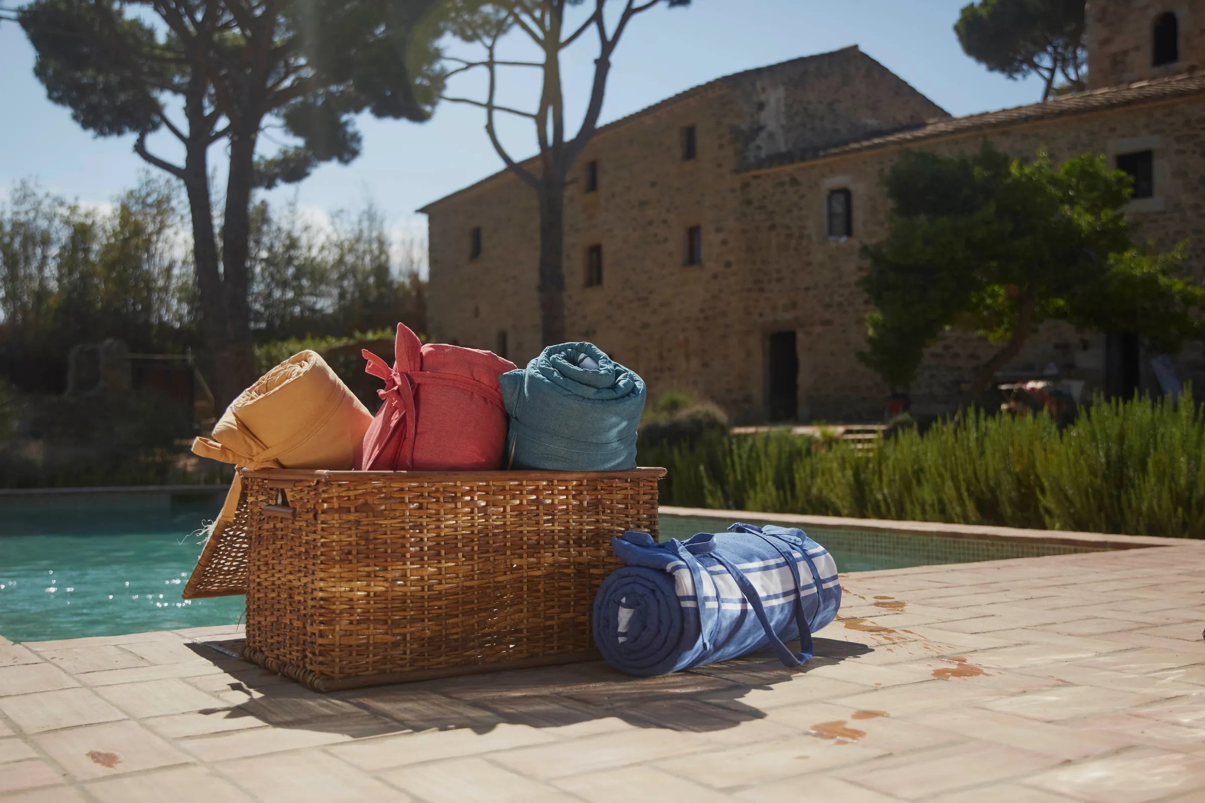 Deckchair mattresses stored in a wicker box - BY FOUTAS