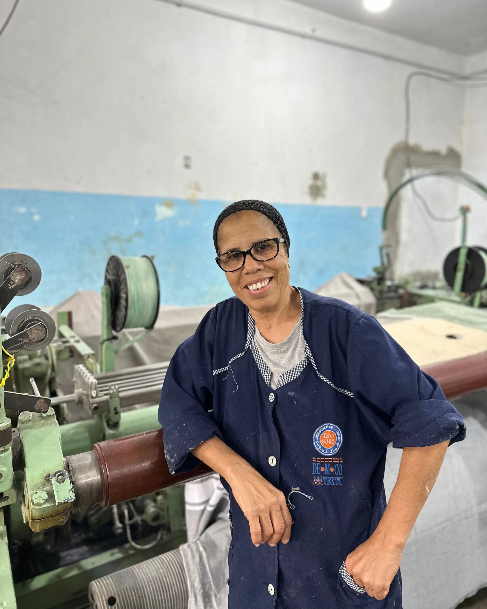 Craftswoman posing in front of a loom - BY FOUTAS